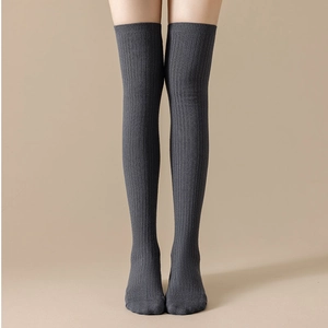 Detailed view of dark grey over-knee socks featuring vertical ribbed knit texture