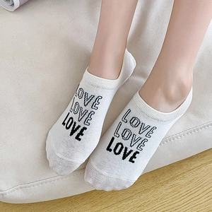 White invisible low cut socks for women with black LOVE pattern and silicone heel grip