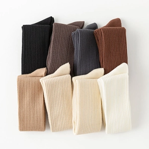 Flat lay of ribbed knit over-the-knee socks in eight neutral earthy color options