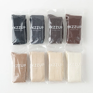 Detailed flat lay of ribbed knit over-knee socks in eight various solid color palettes