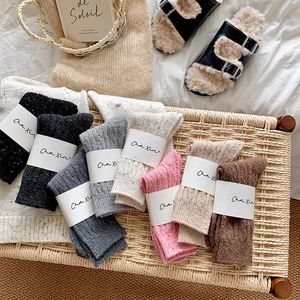 Detail of colorful marl knit socks with texture and branded packaging labels