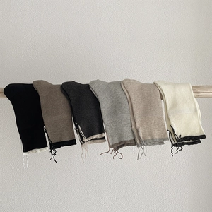 Detail of ribbed knit leg warmers with drawstring ties in six neutral earth tones