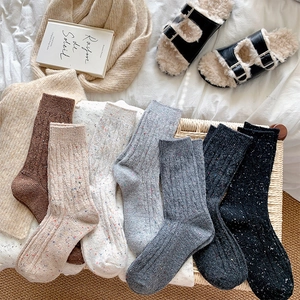 Close-up of thick ribbed knit socks in assorted colors with colorful flecked textures