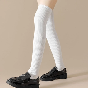 Japanese style white over-the-knee socks with vertical ribbing paired with loafers
