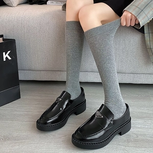 Japanese style gray knee-high socks paired with glossy black platform loafers