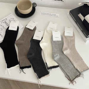 Detailed knit texture of vintage crew socks in six colors with decorative tie-up cuffs