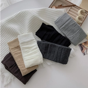 Vertical ribbed knit texture detail on slouchy socks in neutral earth tones