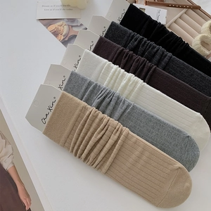 Detailed knit texture of six-color slouch socks including black, grey, and khaki tones