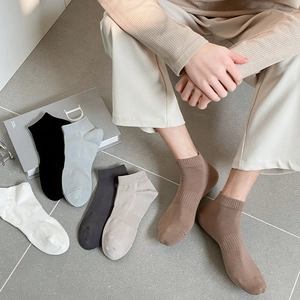 Detailed view of ribbed cuffs on solid color cotton athletic socks in multiple colors