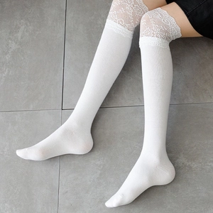 Detail shot of white over-the-knee socks with wide floral lace trim in Lolita style