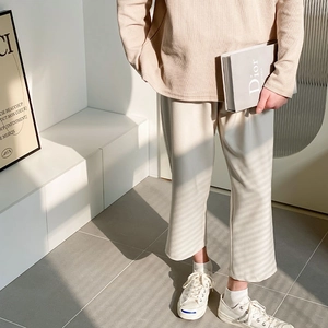 Detail of beige waffle knit long sleeve top and wide leg trousers set with soft texture