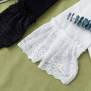 Detail of sweet Lolita style calf socks with elegant lace trim in black and white colors