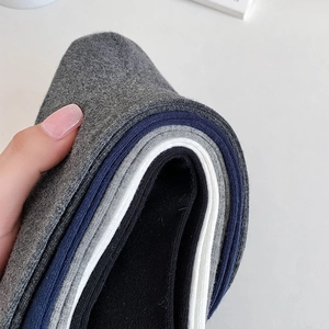 Close-up of four-color cotton calf socks showing thick ribbed knit texture and elasticity
