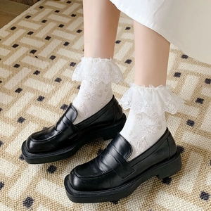 Lolita style white lace socks with floral embroidery paired with black platform loafers
