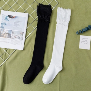Japanese Lolita style knee-high socks in black and white with elegant lace trim details