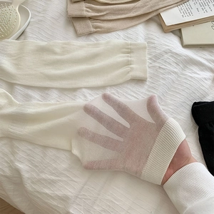 Close-up of sheer breathable ballet style long socks in cream, black and camel colors