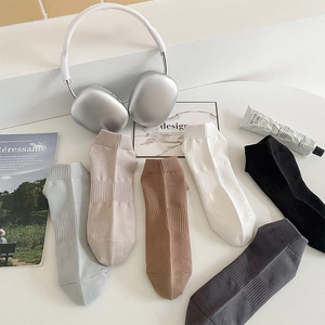 Detail of multi-color cotton ankle socks featuring ribbed cuffs and arch support bands
