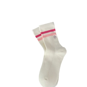 White cotton mid-calf sports socks with pink stripes and purple smiley face embroidery