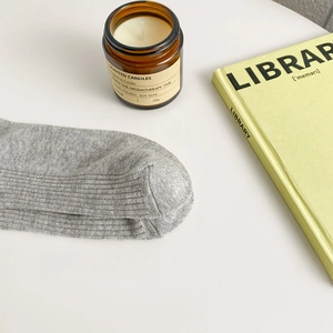 Close-up of grey ribbed knit socks with vertical stripes in a cozy lifestyle setting