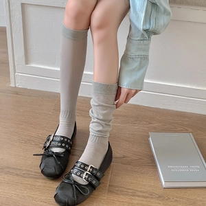 Grey calf-length knit socks shown straight and slouchy with Mary Jane shoes