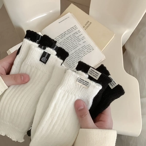 Detailed knit texture and logo label on Japanese style leg warmers with ribbing