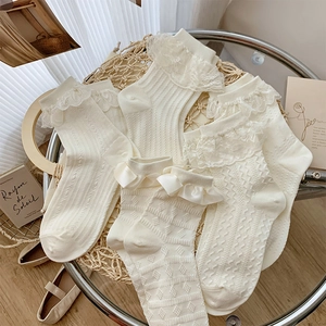 Lace ruffle ankle socks with ribbon bows in French vintage aesthetic display