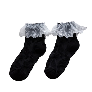 Lolita style black crew socks featuring white floral lace ruffles and textured knit pattern
