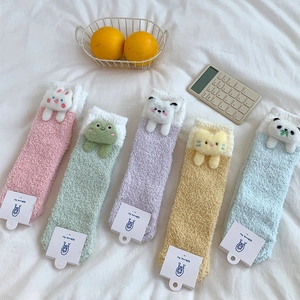 Close-up of fluffy coral fleece socks with cute 3D cartoon animal dolls in five colors