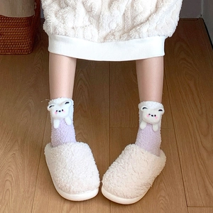 Detail of warm coral fleece socks with 3D cartoon bear doll and plush white slippers