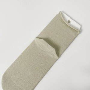 Detailed texture of sage green ribbed cotton mid-calf socks with retail packaging card
