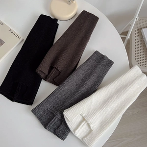 Detail of ribbed knit arm warmers with thumb holes in black, brown, grey, and white
