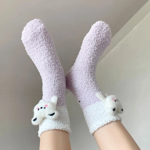 Detail of plush purple coral fleece socks featuring 3D cartoon animal character decor