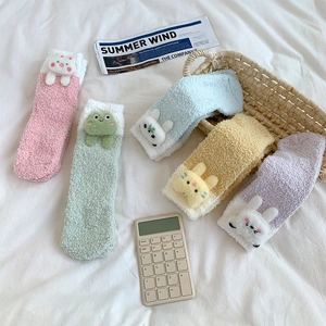 Detail of colorful coral fleece socks with 3D cartoon animal designs in a basket