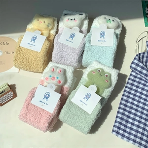 Detailed flat lay of 5 pairs of thick coral fleece socks with 3D cartoon animal dolls