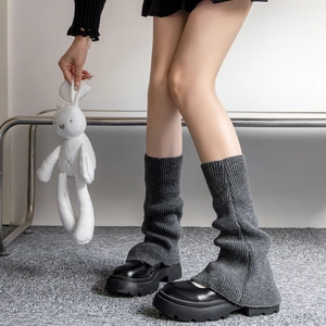 Close-up of grey knit leg warmers with ribbed texture and slouchy winter style