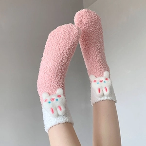 Detailed view of pink coral fleece socks featuring a 3D cute white plush bunny doll