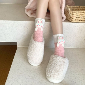 Detail of coral fleece socks with 3D cartoon bunny and soft teddy plush house slippers