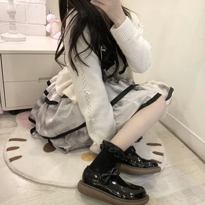 White Lolita lace trim knee-high socks with black Mary Jane shoes and pleated skirt