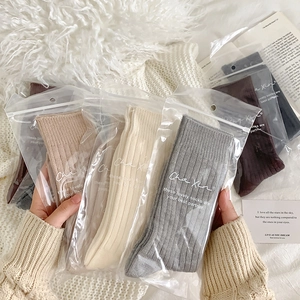 Detailaufnahme von gerippten Thermosocken in Erdtönen mit Reißverschluss-Verpackung