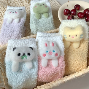 Close-up of five pairs of plush coral fleece warm socks with 3D cartoon animal decorations