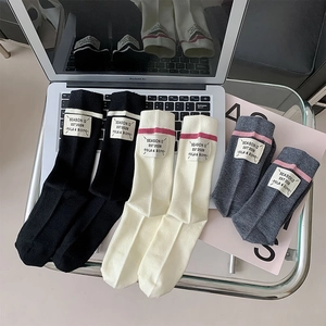 Detailed knit texture of wool blend mid-calf socks in black, beige and dark grey