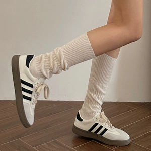 Japanese style cream white ribbed knit knee high socks for women in soft outdoor setting