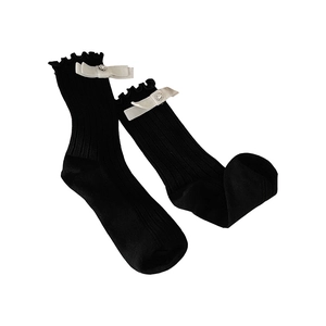 Black ballet-style mid-calf socks with ruffle trim and white satin ribbon bow accent