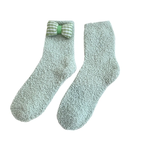 Plush coral fleece winter socks in mint green with sweet plaid bow detail for women