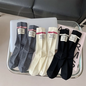 Detailed macro view of soft wool socks with ribbed texture and Season 12 labels