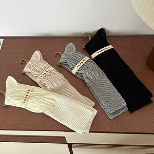 Close-up of four colors ribbed knit calf socks in white, beige, grey and black