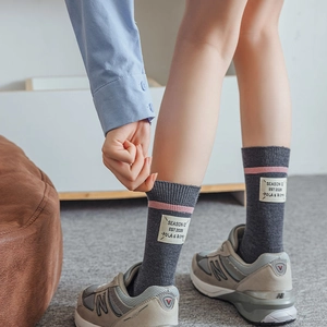 Women's dark gray wool knit socks with pink stripes and vintage fabric label