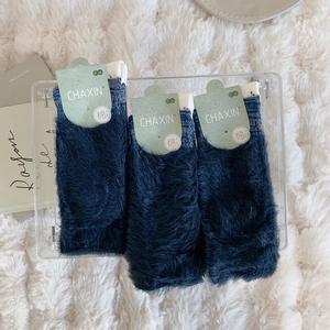 Three pairs of thick fuzzy navy blue socks in soft plush fabric for winter warmth