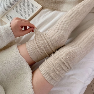 Beige ribbed over-knee wool socks featuring thick knit texture and elastic stretch