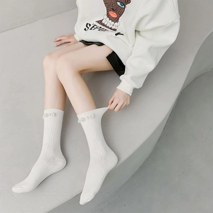 Elegant white calf socks with vertical ribs and decorative pearl details for women